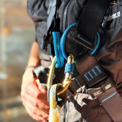 blå och svart fallskyddssele wind 1 pro på modell i ställning